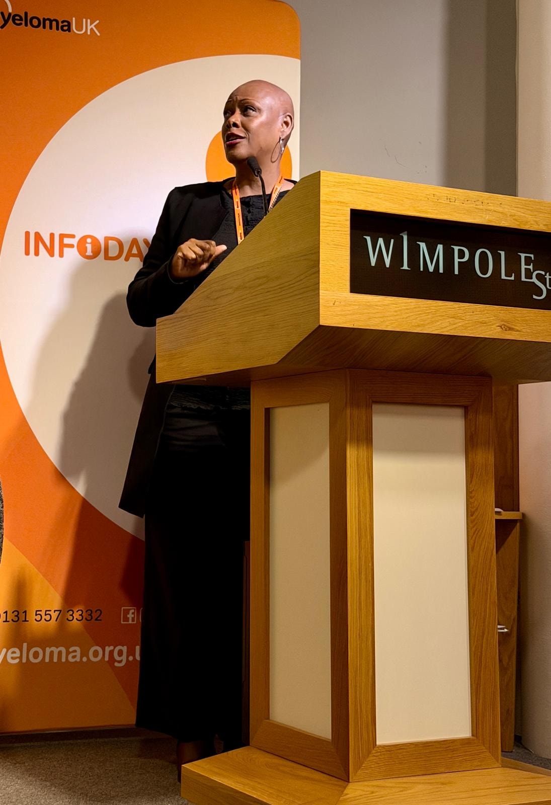 Sharon-Ann Phillips speaking at the lectern at the Myeloma UK Infoday, 1 Wimpole Street, London